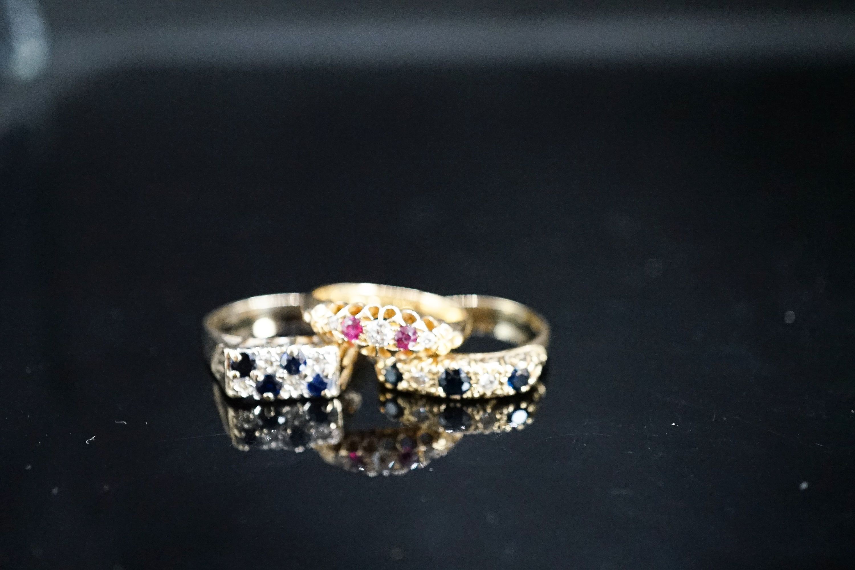 A George V 18ct gold, ruby and diamond chip five stone ring, a later similar sapphire and diamond ring gross 6.7 grams and a 9ct gem set ring, gross 4 grams.